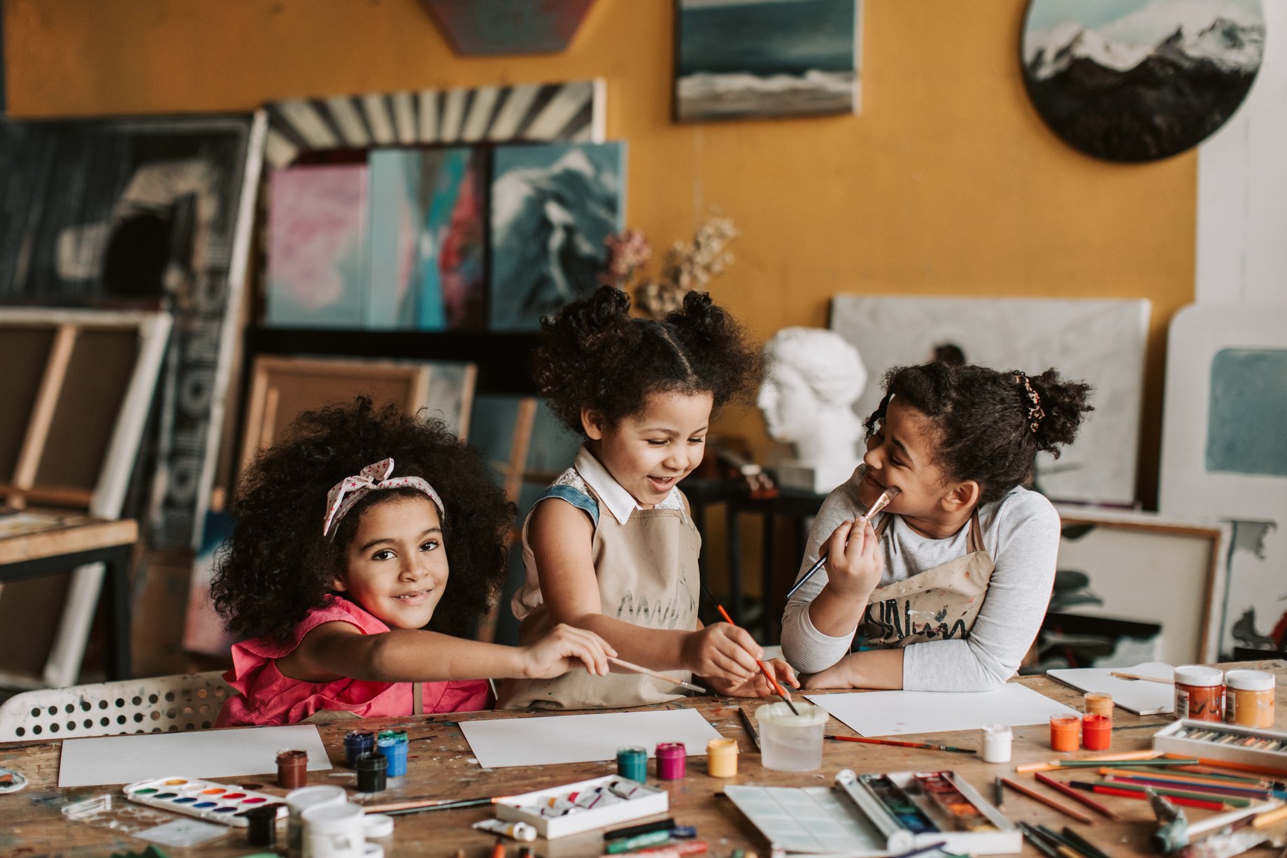 Photo of Children with Curly Hair Painting